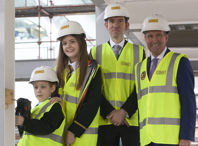 Pupils Lend Helping Hand to Finish Structure of New College Sports Complex 